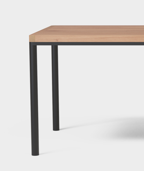 Steel legs integrated into solid wood top.